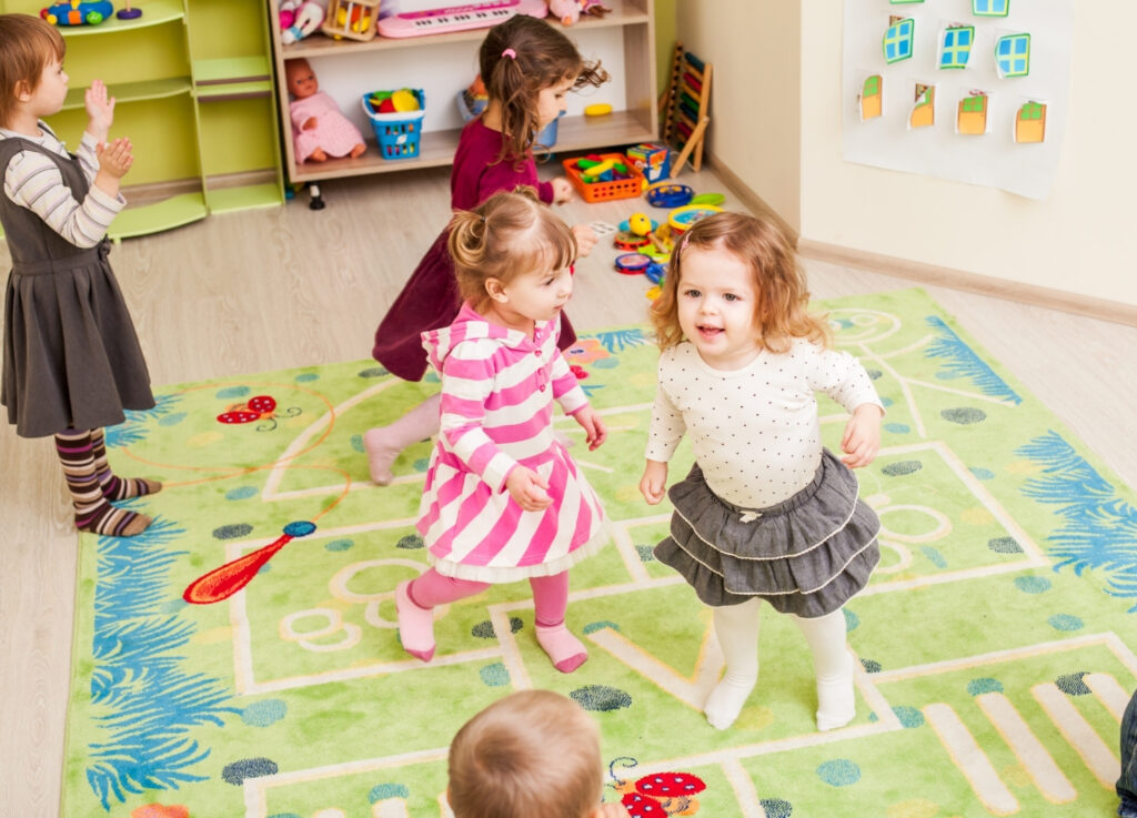 Children in daycare standing on a mat